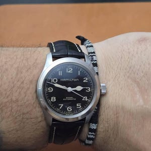 Black alligator leather watch strap on wrist with Hamilton watch