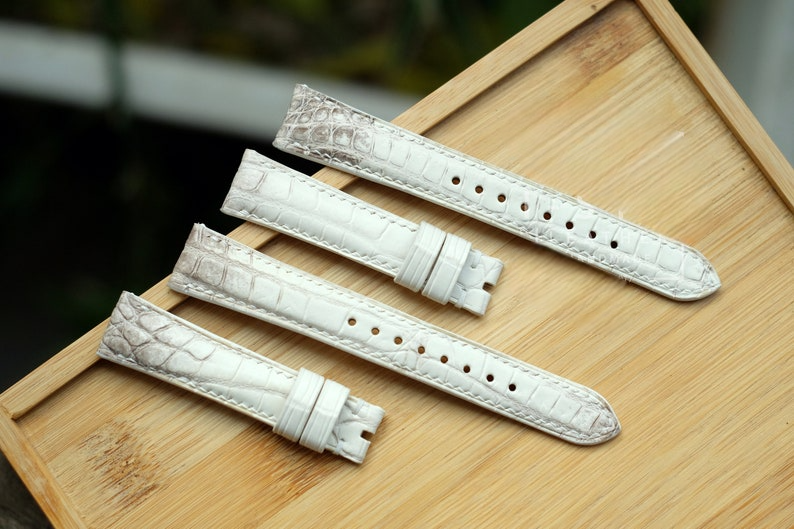 Handmade Himalaya white alligator leather watch straps on wooden display