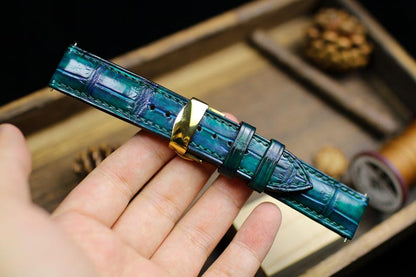 Close-up of teal alligator leather watch strap texture with gold buckle - handcrafted watch band detail
